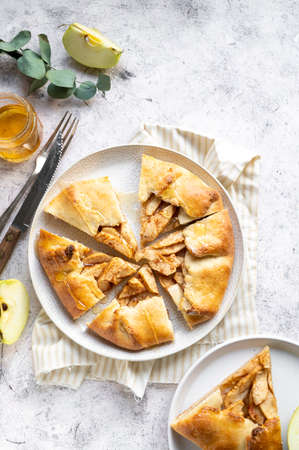 Whole apple tart or galette with cinnamon. Home baking. Top view.の写真素材