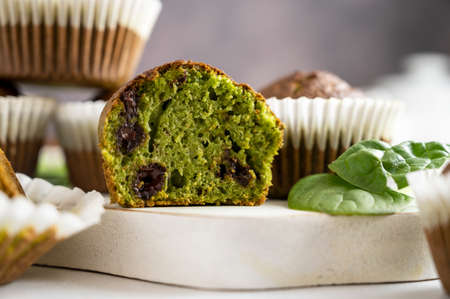 Spinach muffins. Half of a green muffin with fresh spinach leaves. Home bakingsの写真素材