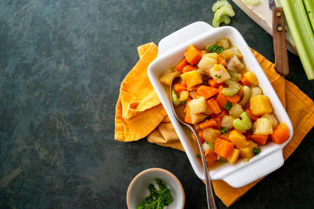 Root vegetable casserole with sweet potato, celery, parsnip, carrot. Comfort baked foodsの写真素材