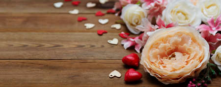 Valentine's day baner. Gift flowers on wooden background with copy space for text.の写真素材