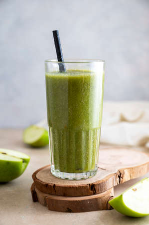 Green apple banana smoothie in glass with paper straw. Healthy lifestyle, dieting and detoxの写真素材