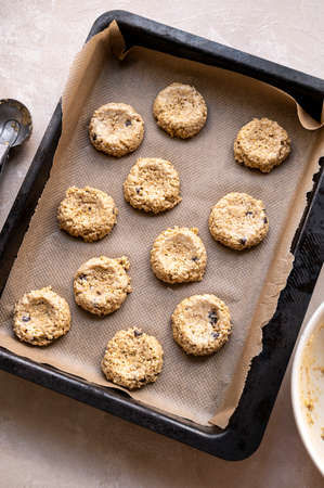 Gluten free raw, uncooked banana cookies with chocolate chips. Healthy homemade biscuits, top view