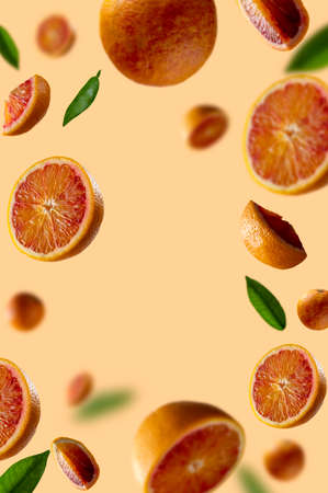 Bloody orange levitation frame. Oranges slices in the aer with green leaves. Selective focus, copy space for textの写真素材