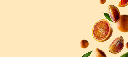 Oranges levitation banner. Oranges slices in the air with green leaves. Abstract citrus fruit...