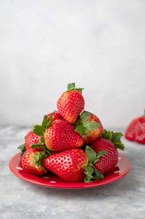 Strawberry fresh fruits in a plate, grey background. Healthy food conceptsの写真素材