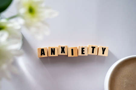 Wooden block with word ANXIETY. Mental health conceptの写真素材