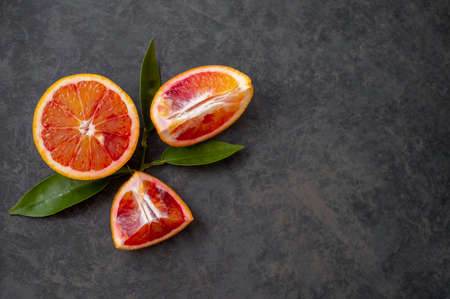 Blood oranges fresh fruits with leaves. Abstract citrus fruit background with copy space for textの写真素材