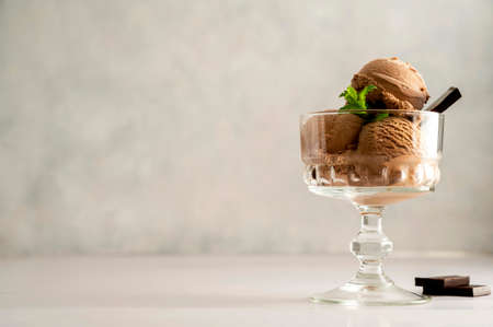 Chocolate vegan ice-cream scoops in glass sundae bowls dessert for summer time, copy space for textの写真素材