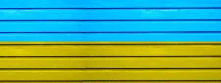 Textured wooden abstract yellow and blue background, wooden plank.の写真素材