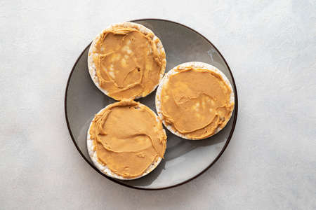 Peanut butter and rice cakes sandwich. Healthy protein snack, breakfast