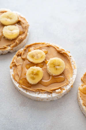 Peanut butter over rice cakes and honey. Healthy protein snack for breakfast food