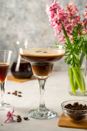 Espresso Martini cocktail drink. Alcohol cocktail with foam and coffee beans. Party drink