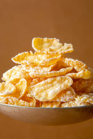 Corn flakes macro, close up on brown backgrounds