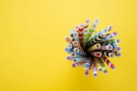 Biodegradable paper eco straws. Zero waste straws on yellow background. Copy space for text.の写真素材