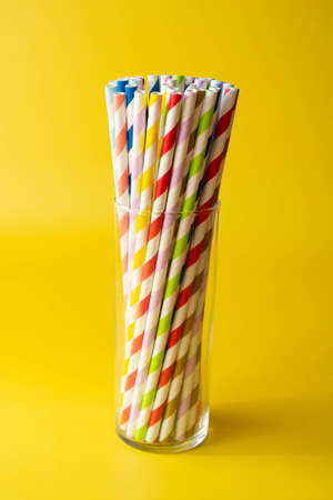 Biodegradable paper eco straws. Zero waste straws on yellow background. Copy space for text.