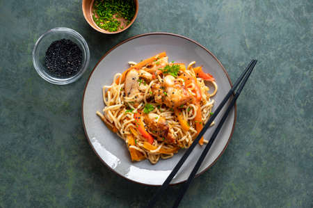 Homemade noodles with chicken meat and vegetable, dark background, asian style food
