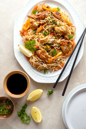 Asian style, stir fry noodles with chicken meat and vegetable, dark background. Homemade foodの写真素材
