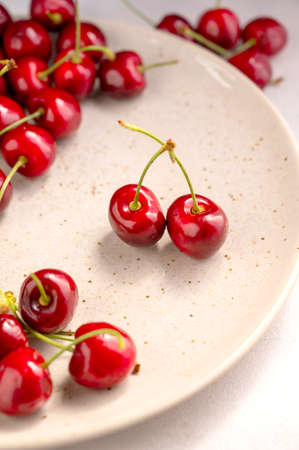 Fresh red cherries, on neutral background. Summer delicious fruits