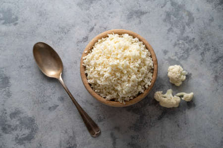 Cauliflower rice in a wooden bowl, cooking healthy food, vegan foodsの写真素材