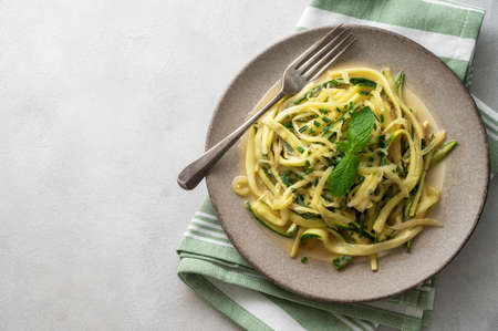 Zucchini courget spaghetti pasta with cheese, clean eating, vegan food, low carb healthy foodsの写真素材