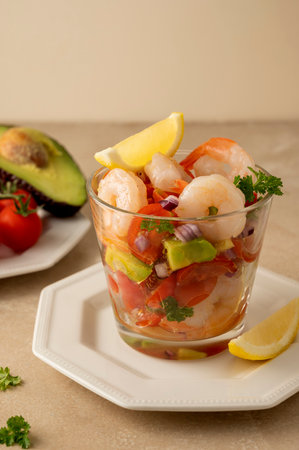 Shrimp cocktail with tomatoe, avocado, red onion and lemon. Shrimp salad served in glass cup.の写真素材