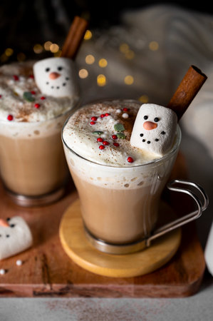 Hot chocolate glass cup with snowman marshmallows. Seasonal, winter or Christmas comfort coffee drinks.の写真素材