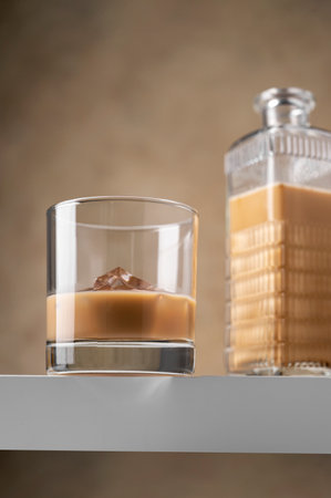 Irish cream liqueur alcohol drink in glass with ice cubes. Part drinkの写真素材