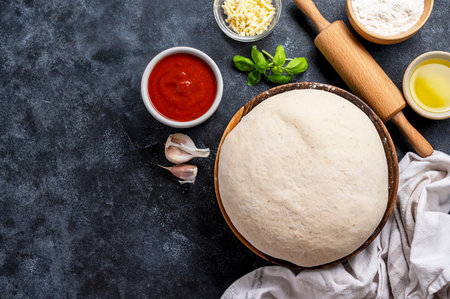 Raw dough with ingredients for cooking pizza. Sourdough pizza, baking at homeの写真素材