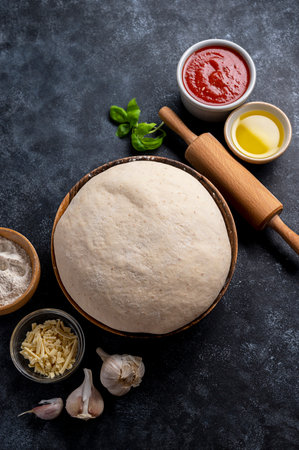 Raw dough with ingredients for cooking pizza. Sourdough pizza, baking at homeの写真素材