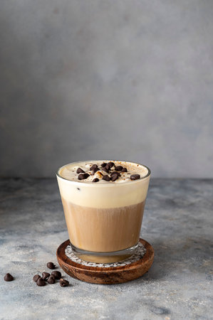Coffee and vanilla ice crem with chocolate , coffee beans in glass cup, copy space. Lisestyle iced coffee drink.の写真素材
