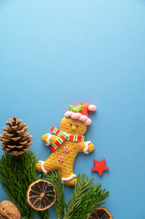 Christmas mock up with fir tree branches, ginger bread cookies, Christmas candy cane on blue...