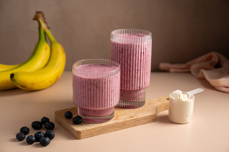 Banana blueberry protein smoothie in a glass.の写真素材