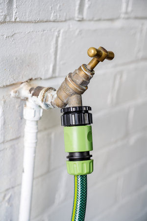 Garden tap, water faucet with connected hosepipeの写真素材