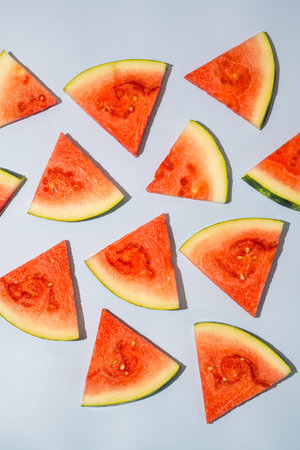 Watermelon triangle slices blue backgroundの写真素材