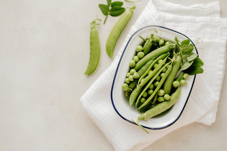 Fresh green peas in a white plate, copy spaceの写真素材