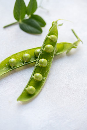 Fresh green peas on a white background, healthy snack