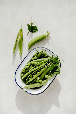Fresh green peas in a white plate, healthy snackの写真素材