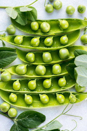 Fresh green peas beans in pods, white background, macro photoの写真素材