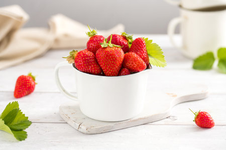 Fresh strawberries in a bowl, summer fruits. Bright background.の写真素材