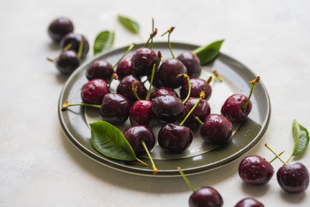 Fresh cherries fruits in a plate, top view, summer fruits. Abstract fruit food photoの写真素材