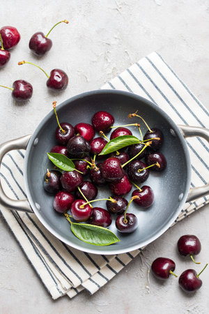 Fresh cherries fruits in a plate, top view, summer fruits. Abstract fruit food photoの写真素材