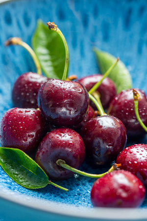 Fresh cherries fruits in a plate, macro photography, summer fruits. Abstract fruit food photoの写真素材