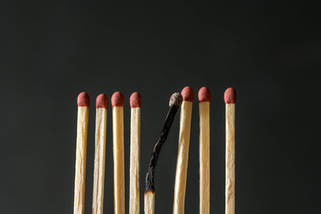 Matches and one burned match. Abstract concept of burnout, stress and depressionの写真素材