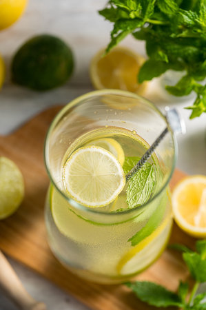 A glass jug with lemonade with lemons, limes and fresh mint, summer drinkの写真素材
