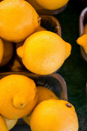 Closeup lemons In fruit market display, outdoor farm market stallの写真素材