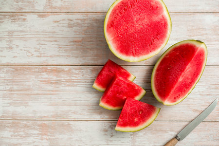 Slices of fresh watermelon on bright rustic wooden table, copy spaceの写真素材