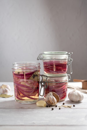 Cooking homemade pickled red onions in jars, bright backgroundの写真素材