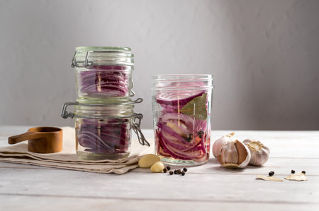 Homemade pickled red onions in jars, bright backgroundの写真素材