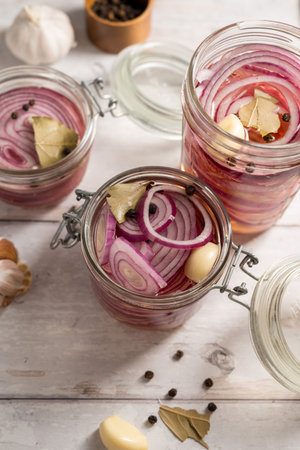 Homemade pickled red onions in jars, bright backgroundの写真素材