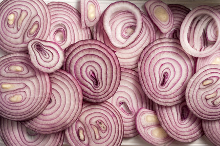 Slices of red onions closeup food backgroundの写真素材